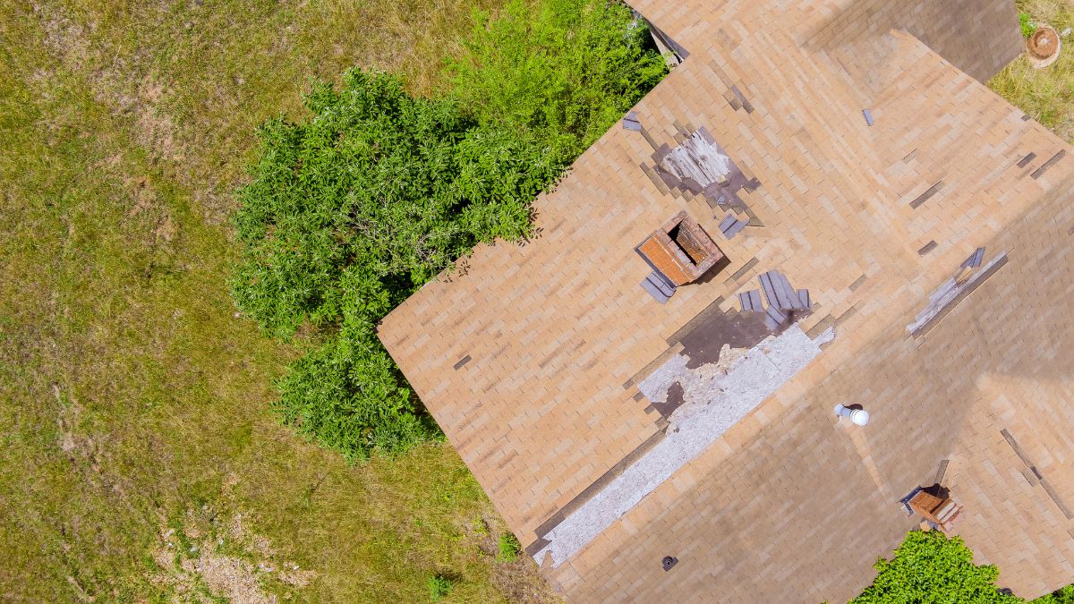 Birds eye view of a damaged roof with missing shingles